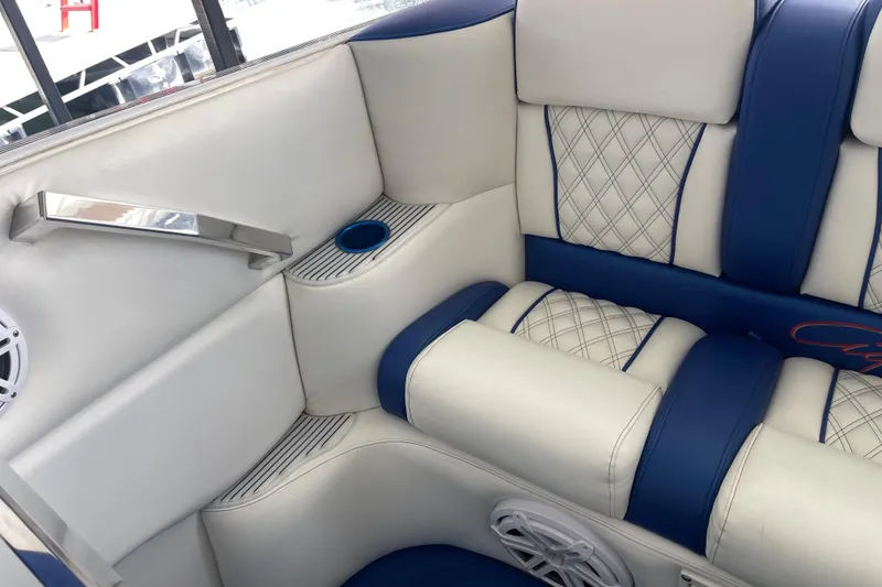 Slide: The Image of 1998 Cigarette 38' Top Gun boat interior with blue and white leather seating. - 19