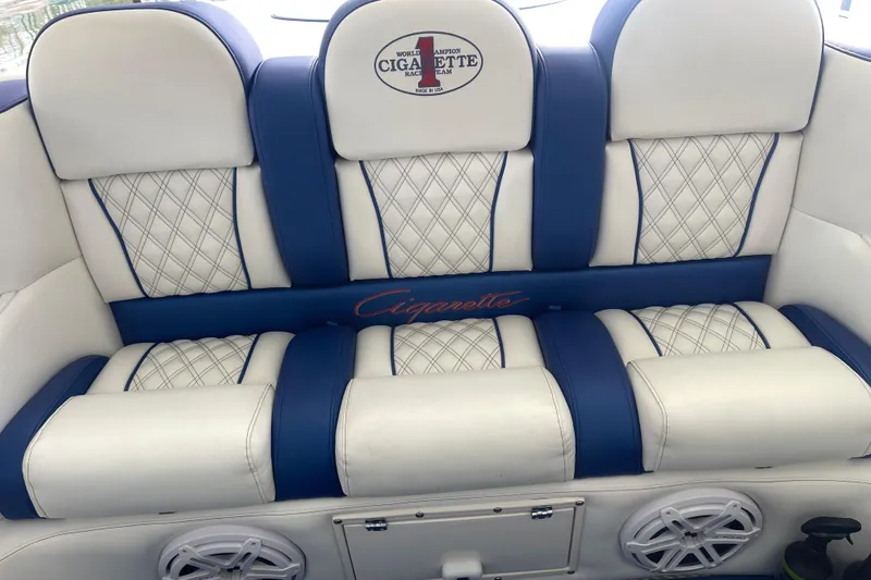 Slide: The Image of Luxurious seating in a 1998 Cigarette 38' Top Gun boat with blue and white upholstery. - 20