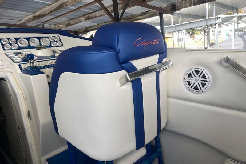 Slide: The Image of 1998 Cigarette 38' Top Gun boat interior with blue and white seating and dashboard. - 22