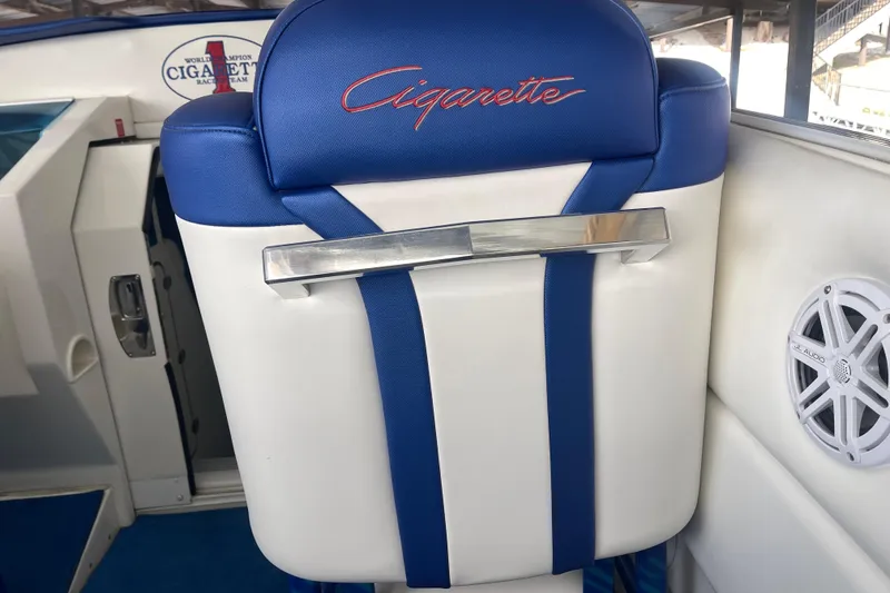 Slide: The Image of 1998 Cigarette 38' Top Gun boat interior with blue and white seating and JL Audio speaker. - 23