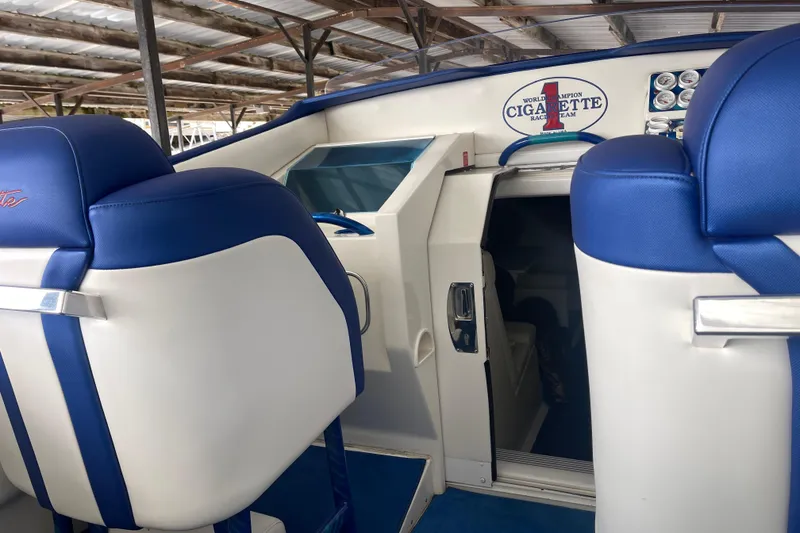 Slide: The Image of Interior of a 1998 Cigarette 38' Top Gun boat with blue and white seating. - 24