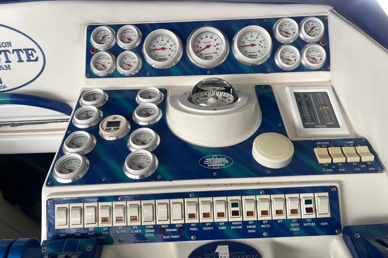 Slide: The Image of Control panel of a 1998 Cigarette 38' Top Gun boat with gauges and switches. - 28