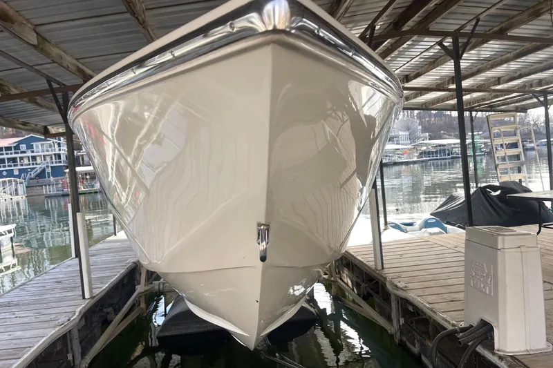 Slide: The Image of 1998 Cigarette 38' Top Gun boat docked under a covered marina. - 3