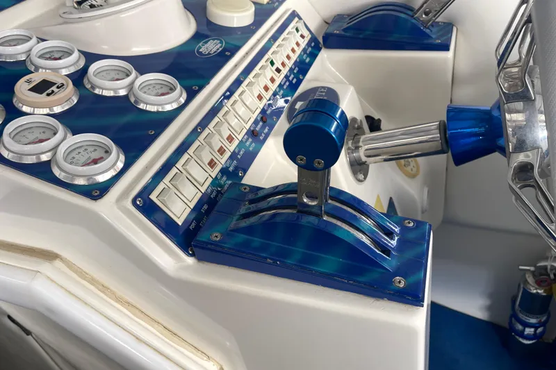 Slide: The Image of Control panel of a 1998 Cigarette 38' Top Gun boat with gauges and switches. - 30