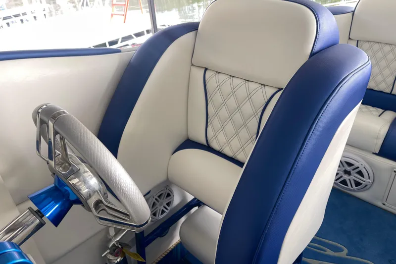 Slide: The Image of Interior of 1998 Cigarette 38' Top Gun boat with blue and white seating. - 31