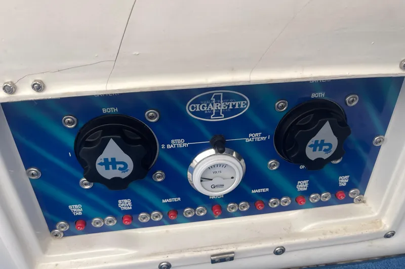 Slide: The Image of Control panel of a 1998 Cigarette 38' Top Gun boat with battery switches. - 33