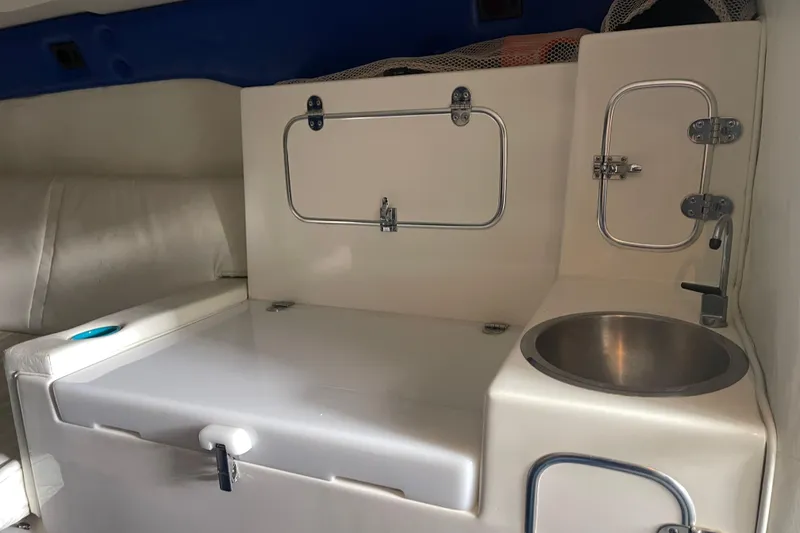 Slide: The Image of Interior of 1998 Cigarette 38' Top Gun boat with sink and storage compartments. - 36