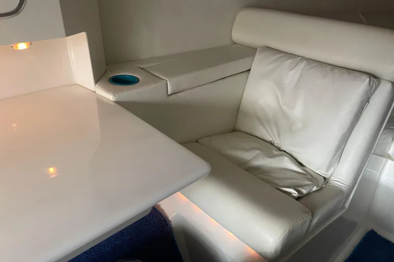 Slide: The Image of Interior of 1998 Cigarette 38' Top Gun boat with white seating and table. - 37