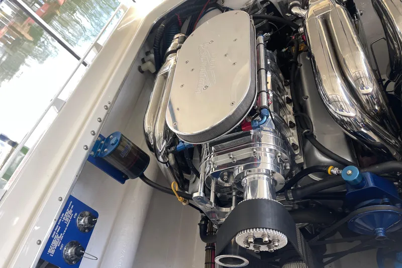 Slide: The Image of Engine of a 1998 Cigarette 38' Top Gun boat, showcasing polished components. - 46