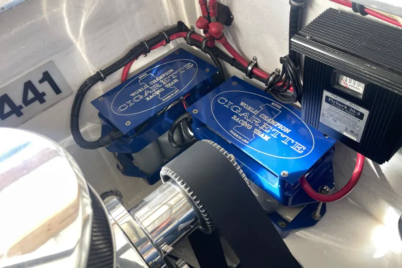 Slide: The Image of Engine compartment of a 1998 Cigarette 38' Top Gun boat, featuring blue components and wiring. - 49