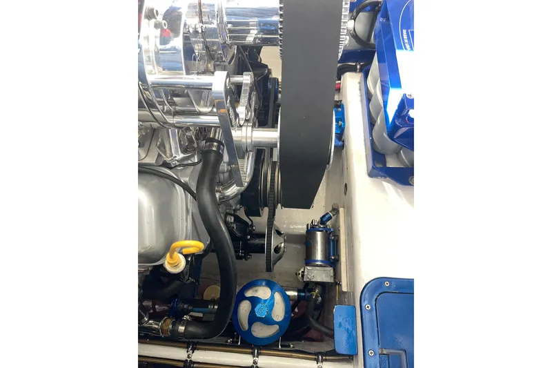 Slide: The Image of Engine compartment of a 1998 Cigarette 38' Top Gun boat, showcasing mechanical components. - 52