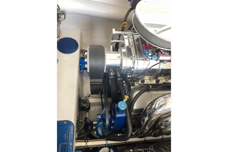 Slide: The Image of Engine compartment of a 1998 Cigarette 38' Top Gun boat, showcasing polished components. - 53