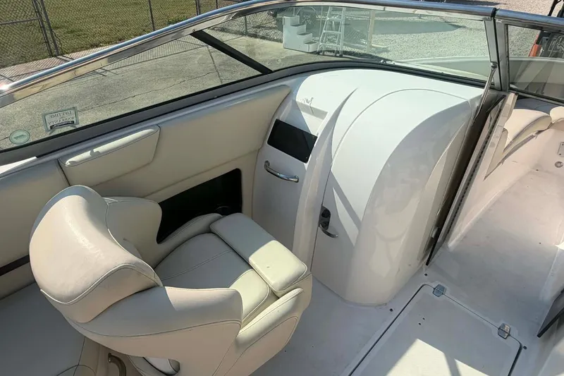 Slide: The Image of 2009 Regal 2500 Bowrider interior with white seating and dashboard, showcasing luxury design. - 10