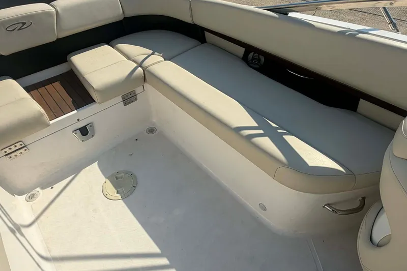 Slide: The Image of 2009 Regal 2500 Bowrider interior with beige seating and clean deck. - 11