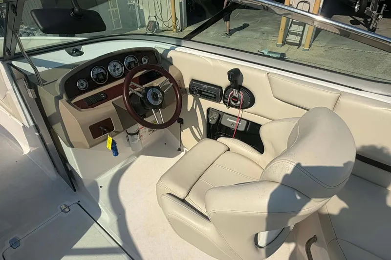 Slide: The Image of 2009 Regal 2500 Bowrider boat interior with steering wheel and control panel. - 13