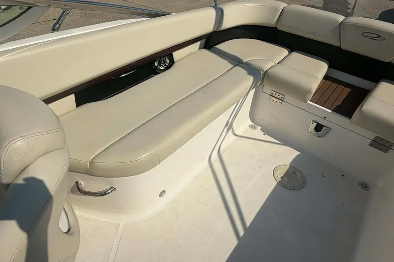 Slide: The Image of 2009 Regal 2500 Bowrider interior with beige seating and wood accents. - 14