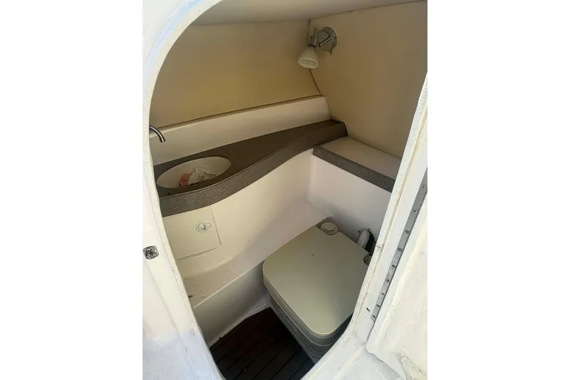 Slide: The Image of 2009 Regal 2500 Bowrider boat interior with compact bathroom amenities. - 15