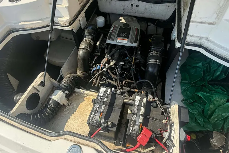 Slide: The Image of Engine compartment of a 2009 Regal 2500 Bowrider with visible batteries and wiring. - 17