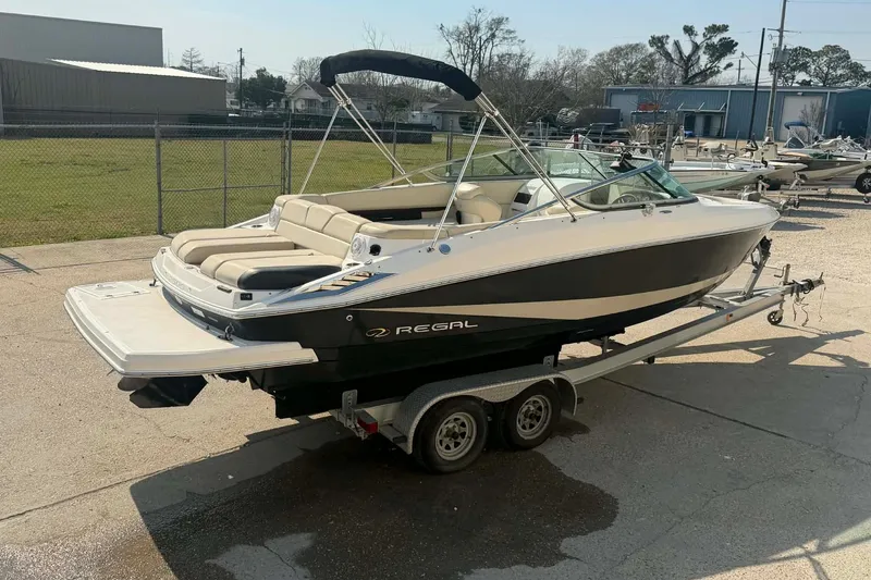 Slide: The Image of 2009 Regal 2500 Bowrider boat on trailer, parked outdoors. - 5