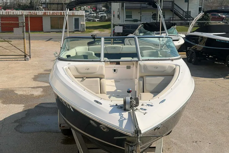 Slide: The Image of 2009 Regal 2500 Bowrider boat on trailer, parked outdoors in a marina. - 6
