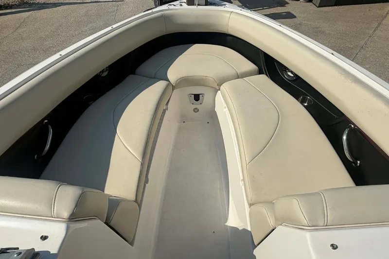 Slide: The Image of 2009 Regal 2500 Bowrider boat interior with beige seating and spacious layout. - 7