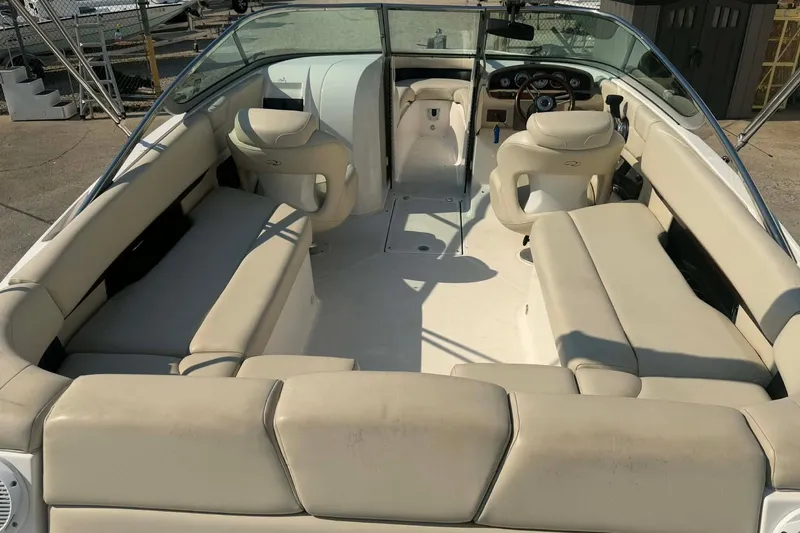 Slide: The Image of 2009 Regal 2500 Bowrider interior with beige seating and steering console. - 8