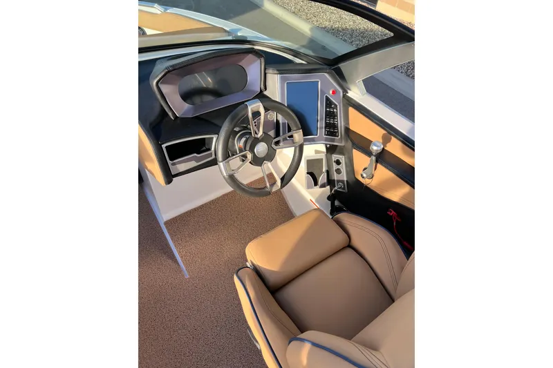 Slide: The Image of 2022 MasterCraft XT25 boat interior with modern dashboard and steering wheel. - 14