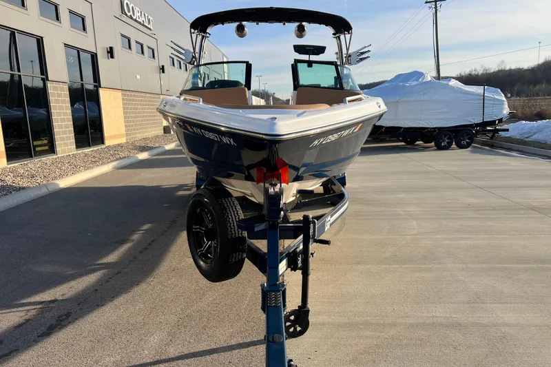 Slide: The Image of 2022 MasterCraft XT25 boat on trailer outside dealership, sunny day. - 8