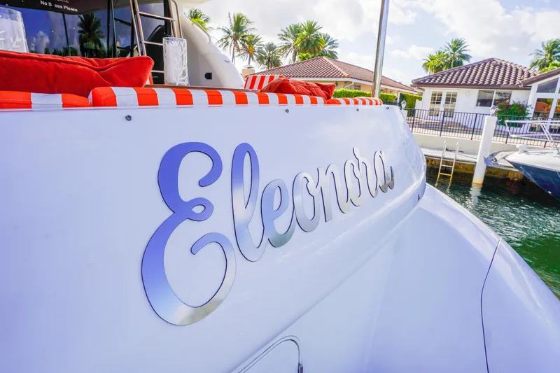 Slide: The Image of Luxury yacht "Eleonora" docked, featuring Lazzara 80 SL, 2004 model, with vibrant cushions. - 13