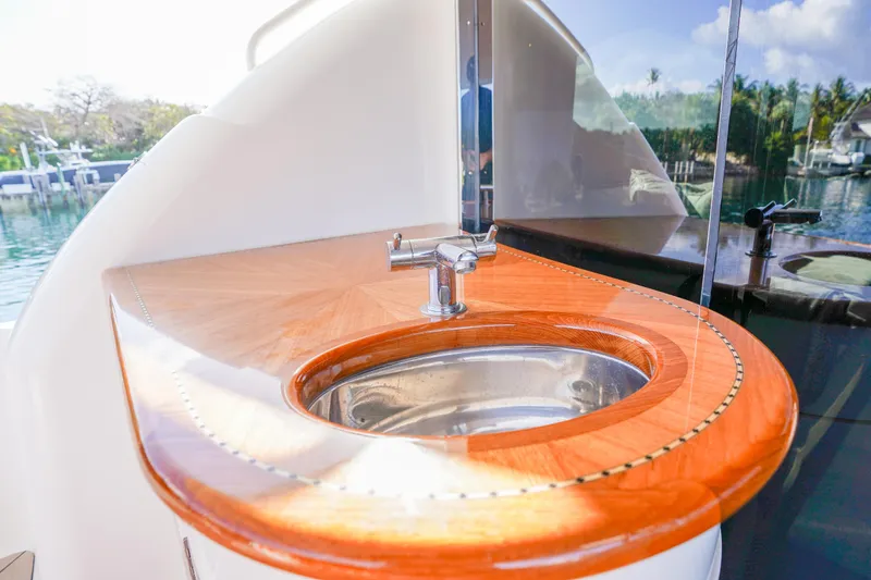 Slide: The Image of Luxurious 2004 Lazzara 80 SL yacht sink with polished wood finish and modern faucet. - 17