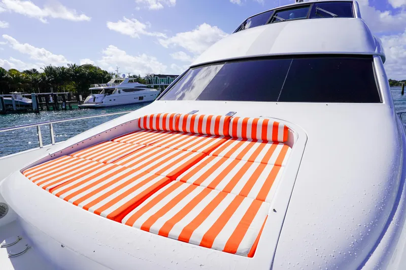Slide: The Image of Luxurious 2004 Lazzara 80 SL yacht with striped sunbed on deck, docked by the water. - 20