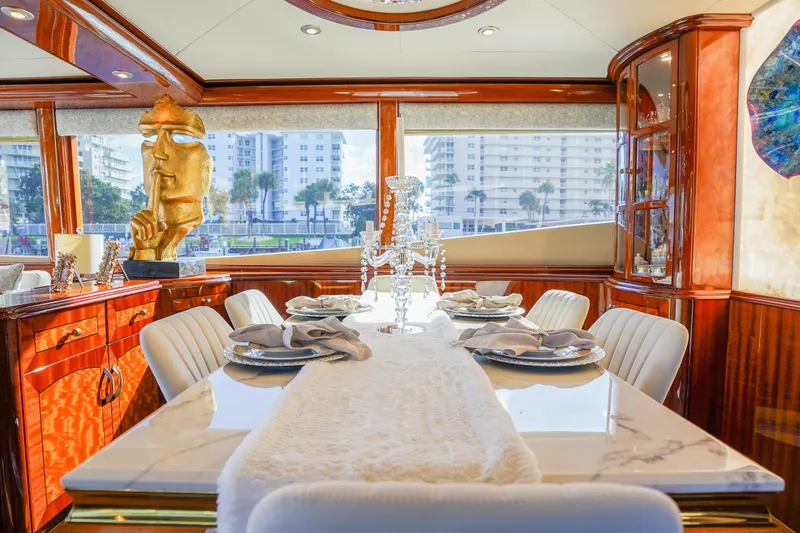 Slide: The Image of Luxurious dining area on a 2004 Lazzara 80 SL yacht with elegant decor and city view. - 28