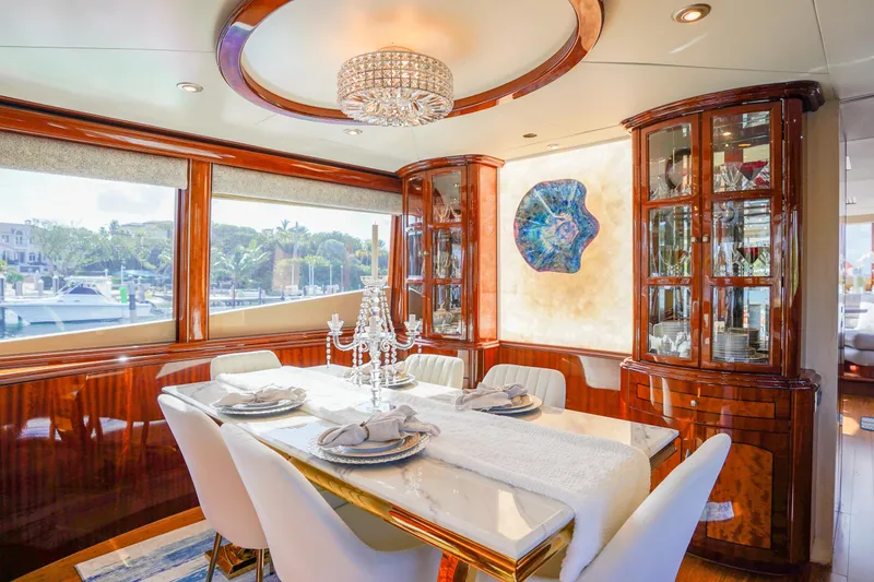 Slide: The Image of Luxurious dining area on a 2004 Lazzara 80 SL yacht with elegant decor and marina view. - 30