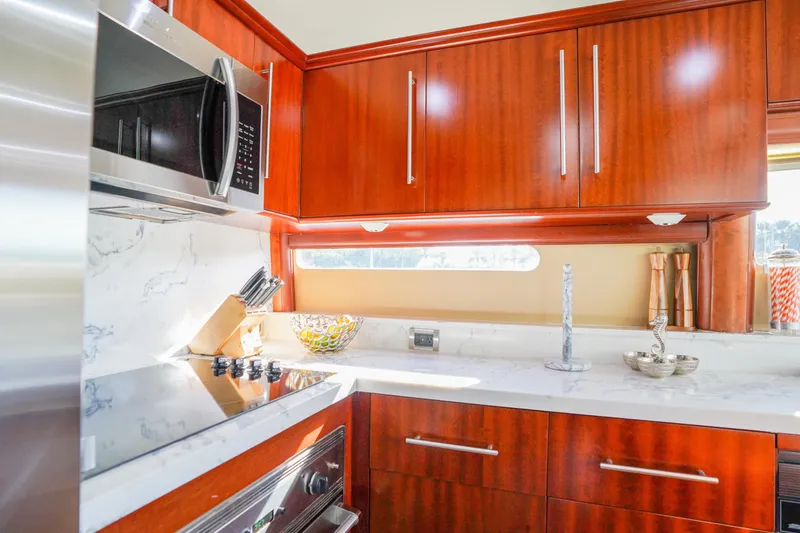 Slide: The Image of Luxurious kitchen interior of 2004 Lazzara 80 SL yacht with modern appliances and wood cabinetry. - 32