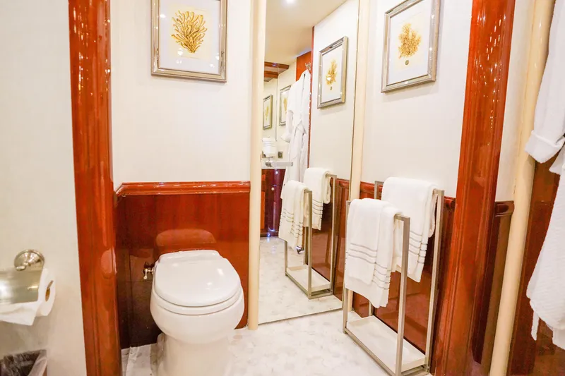 Slide: The Image of Luxurious bathroom in 2004 Lazzara 80 SL yacht with elegant wood paneling and framed artwork. - 48