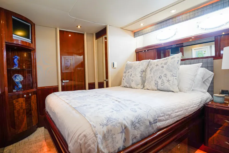Slide: The Image of Luxurious bedroom interior of 2004 Lazzara 80 SL yacht with elegant bedding and wood finishes. - 50