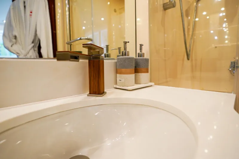 Slide: The Image of Luxury yacht bathroom with modern sink and stylish soap dispensers, Lazzara 80 SL, 2004 model. - 53