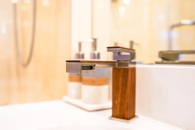 Slide: The Image of Modern bathroom faucet with wooden accents on a Lazzara 80 SL yacht, 2004 model. - 57