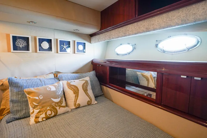Slide: The Image of Luxurious 2004 Lazzara 80 SL yacht bedroom with nautical decor and porthole windows. - 59