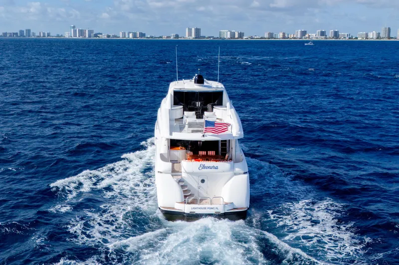 Slide: The Image of Luxury 2004 Lazzara 80 SL yacht cruising near city skyline on blue ocean. - 6