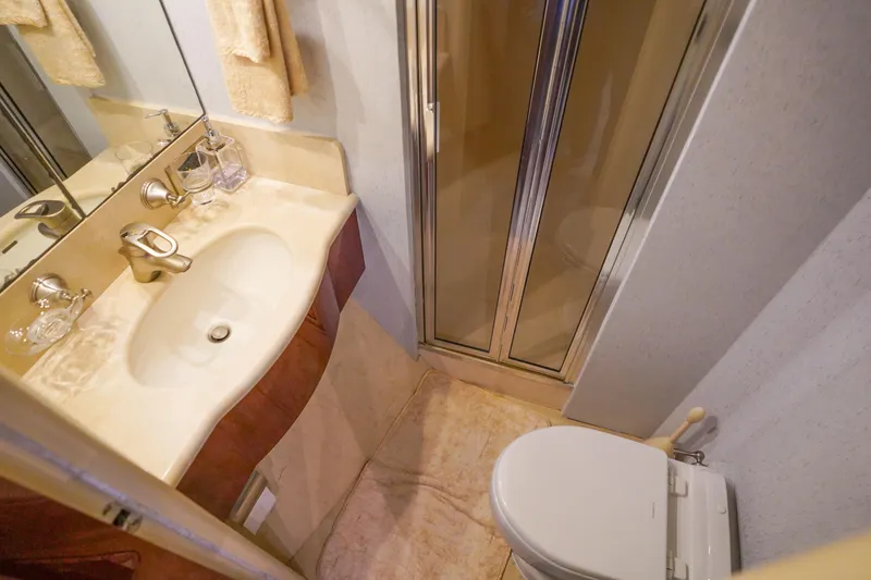 Slide: The Image of Luxurious bathroom in 2004 Lazzara 80 SL yacht with sink, shower, and toilet. - 62