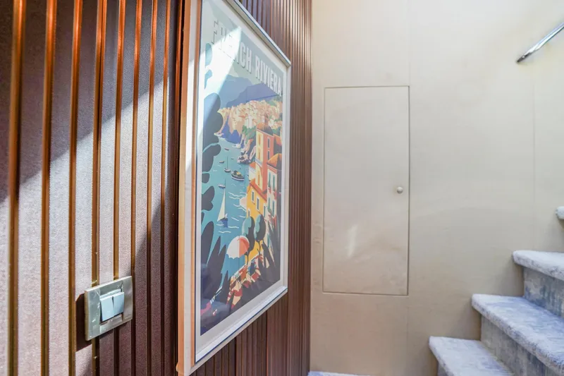 Slide: The Image of Interior of 2004 Lazzara 80 SL yacht with artwork and staircase. - 64