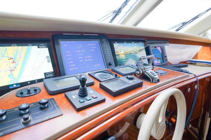 Slide: The Image of Control panel of 2004 Lazzara 80 SL yacht with navigation screens and controls. - 66