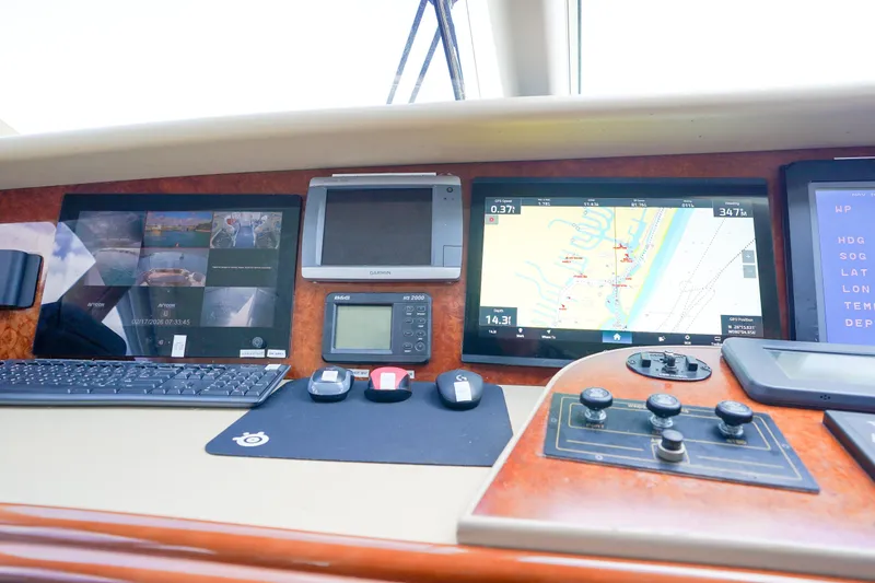 Slide: The Image of Control panel of a 2004 Lazzara 80 SL yacht with navigation screens and controls. - 67