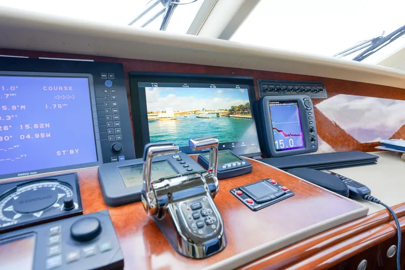 Slide: The Image of Control panel of 2004 Lazzara 80 SL yacht with navigation screens and controls. - 69