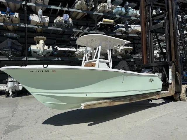 Slide: The Image of 2022 Sea Hunt 234 boat on forklift in storage facility. - 2