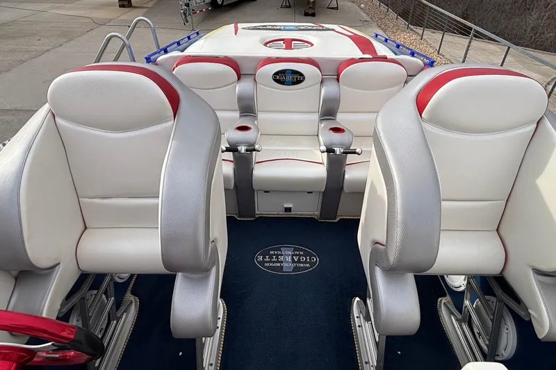 Slide: The Image of Interior of a 2003 Cigarette 38' Top Gun boat with white and red seating. - 13