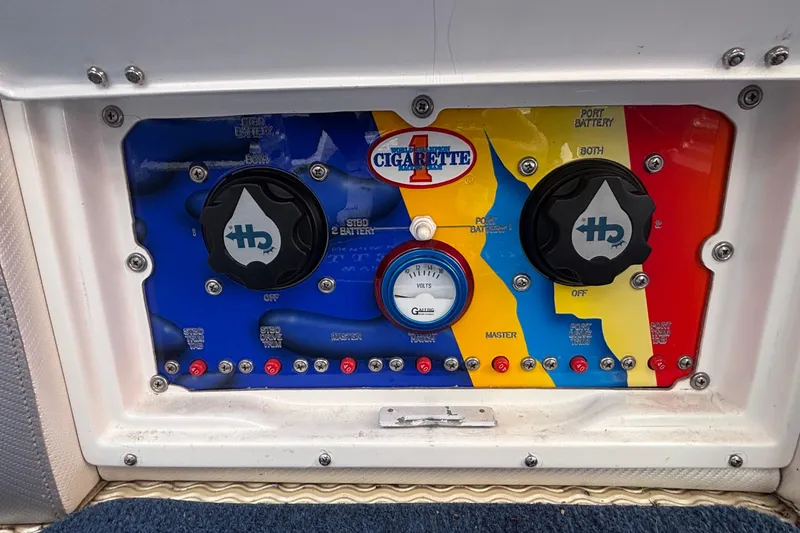 Slide: The Image of Control panel of a 2003 Cigarette 38' Top Gun boat with colorful design and gauges. - 16