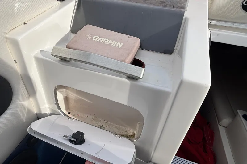 Slide: The Image of 2003 Cigarette 38' Top Gun boat interior with Garmin device and storage compartment. - 17