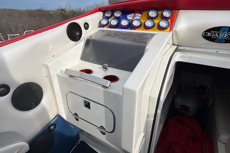 Slide: The Image of 2003 Cigarette 38' Top Gun boat dashboard with gauges and storage compartment. - 18